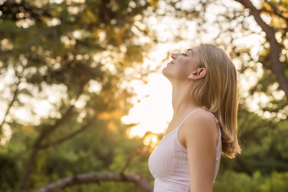 Woman breathing fresh in forest